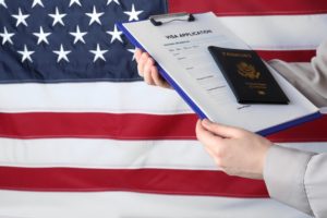 Immigration lawyer handing United States passport to client