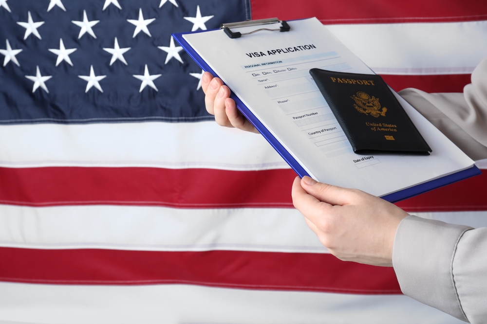 Immigration lawyer handing United States passport to client