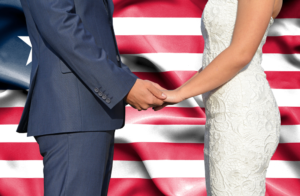 marriage green cards with couple holding hands in front of usa flag