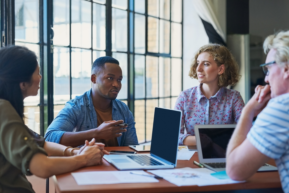 EB-1 visa holders discussing tech topics in San Diego