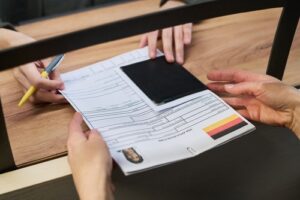 Woman handing visa card across counter during payment transaction at checkout terminal